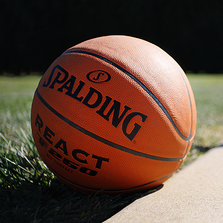 Close up image of React TF 250 Basketball in the grass.  